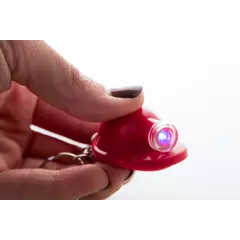 Helmet shaped keychain with an LED flashlight