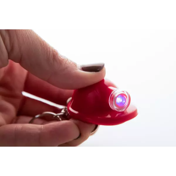 Helmet shaped keychain with an LED flashlight